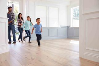 family walking on a wooden floor