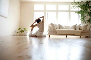 woman doing yoga on a wooden floor