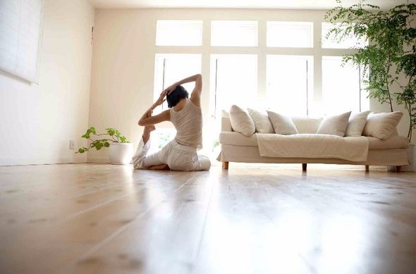 woman doing yoga on a wooden floor