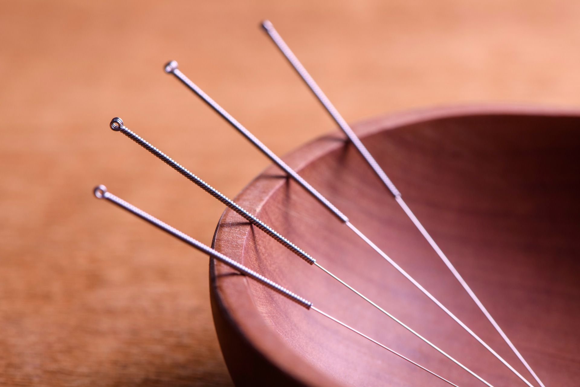 A bowl of acupuncture needles on a table