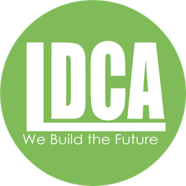 A circular lime green logo with white text reading 