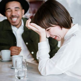 people laughing at a table 