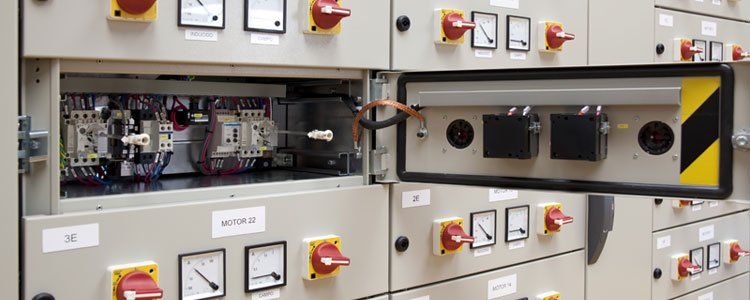 A close up of a electrical panel with the door open.
