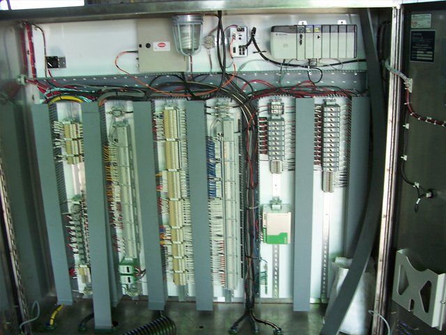 A large electrical box with a lot of wires coming out of it