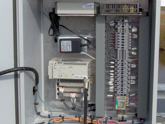 A large electrical box with a lot of wires coming out of it