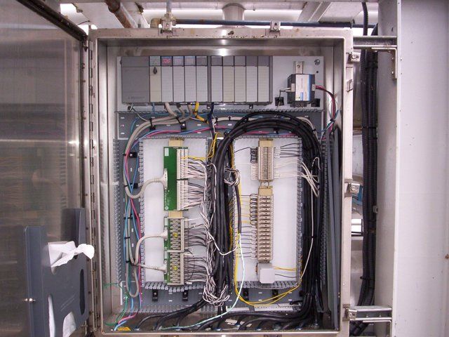 A stainless steel box with a bunch of wires coming out of it