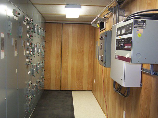A room with a lot of electrical boxes on the wall