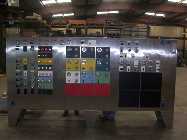 A large stainless steel wall with a bunch of buttons on it