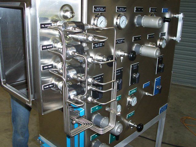 A stainless steel machine with many buttons and gauges