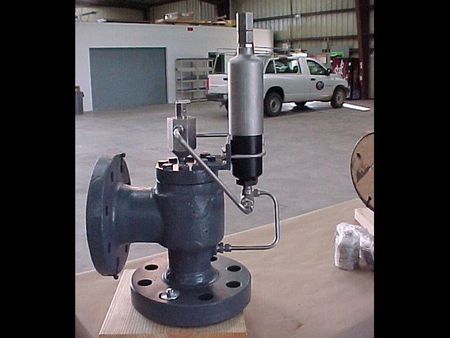 A valve is sitting on a table in front of a white truck
