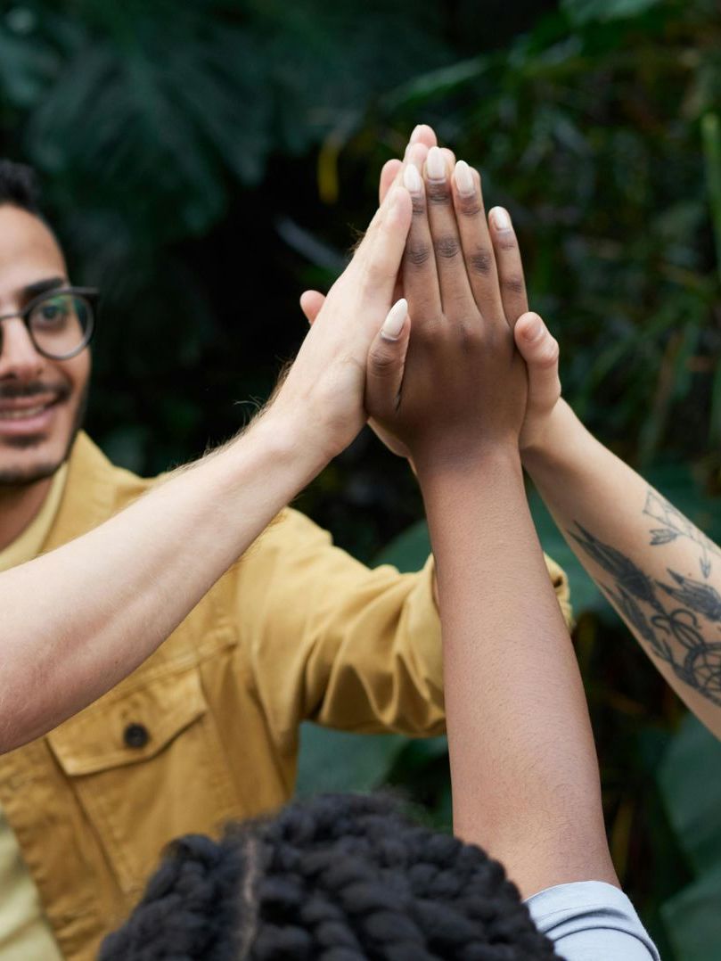 A group of people are giving each other a high five