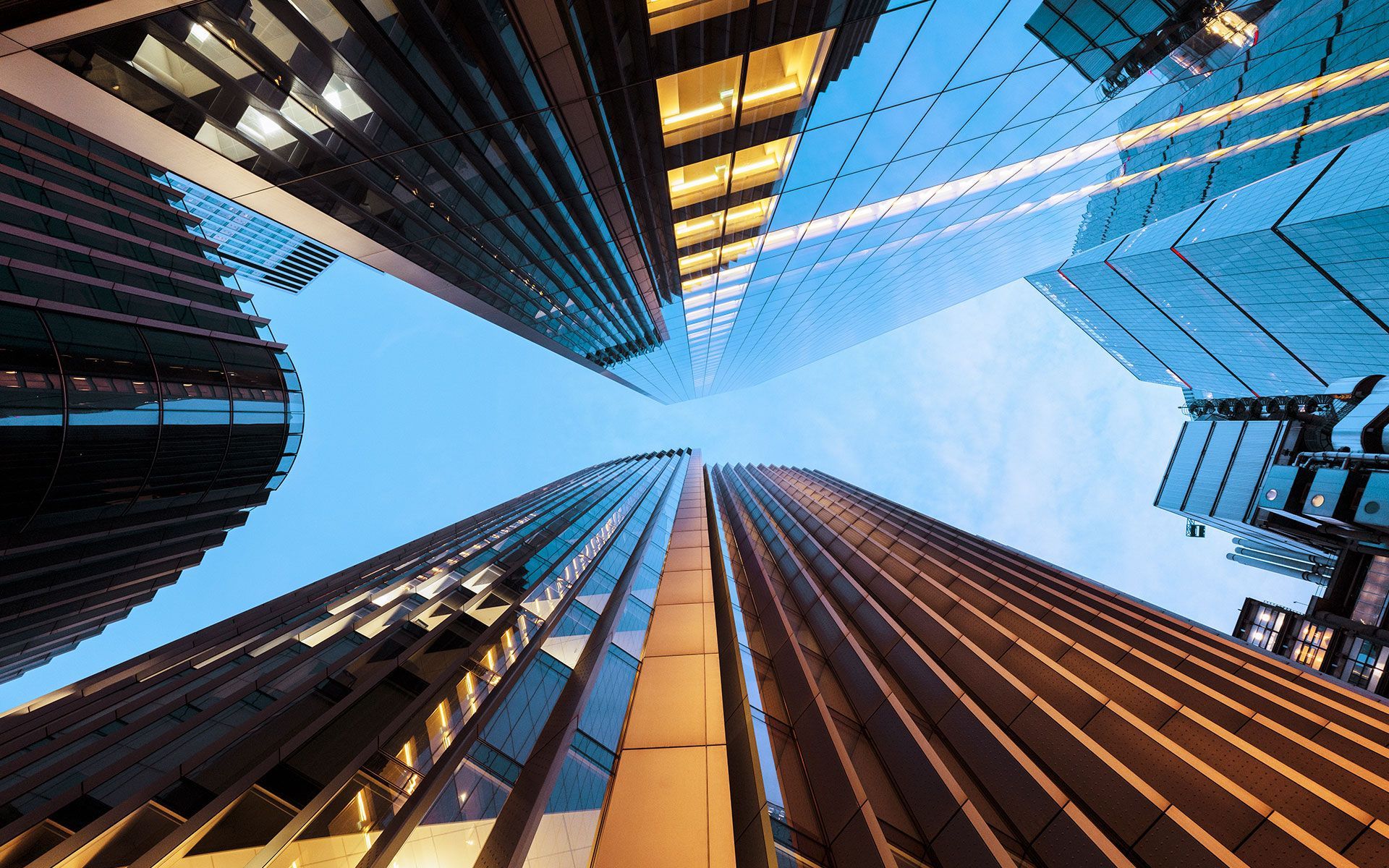 View of skyscrapers from a low angle, with blue sky visible.