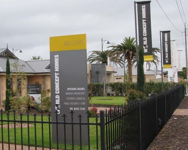 grey and yellow display homes sign