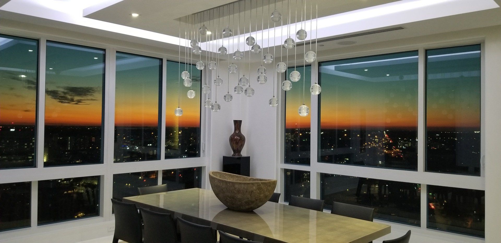 A large dining room with a table and chairs and a chandelier.