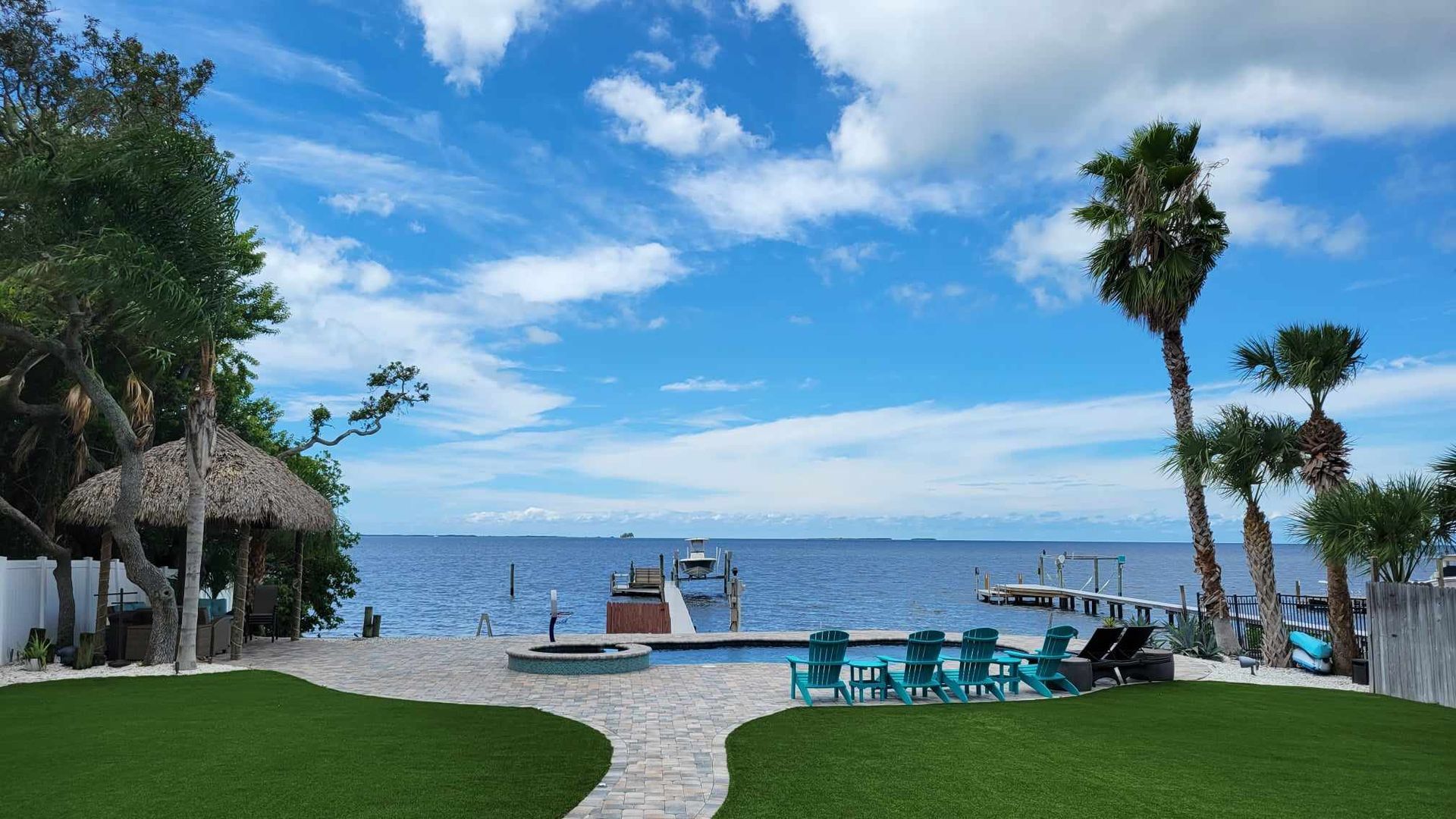 There is a dock with a boat docked in the water.