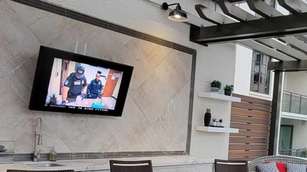 A living room with a large chandelier hanging from the ceiling