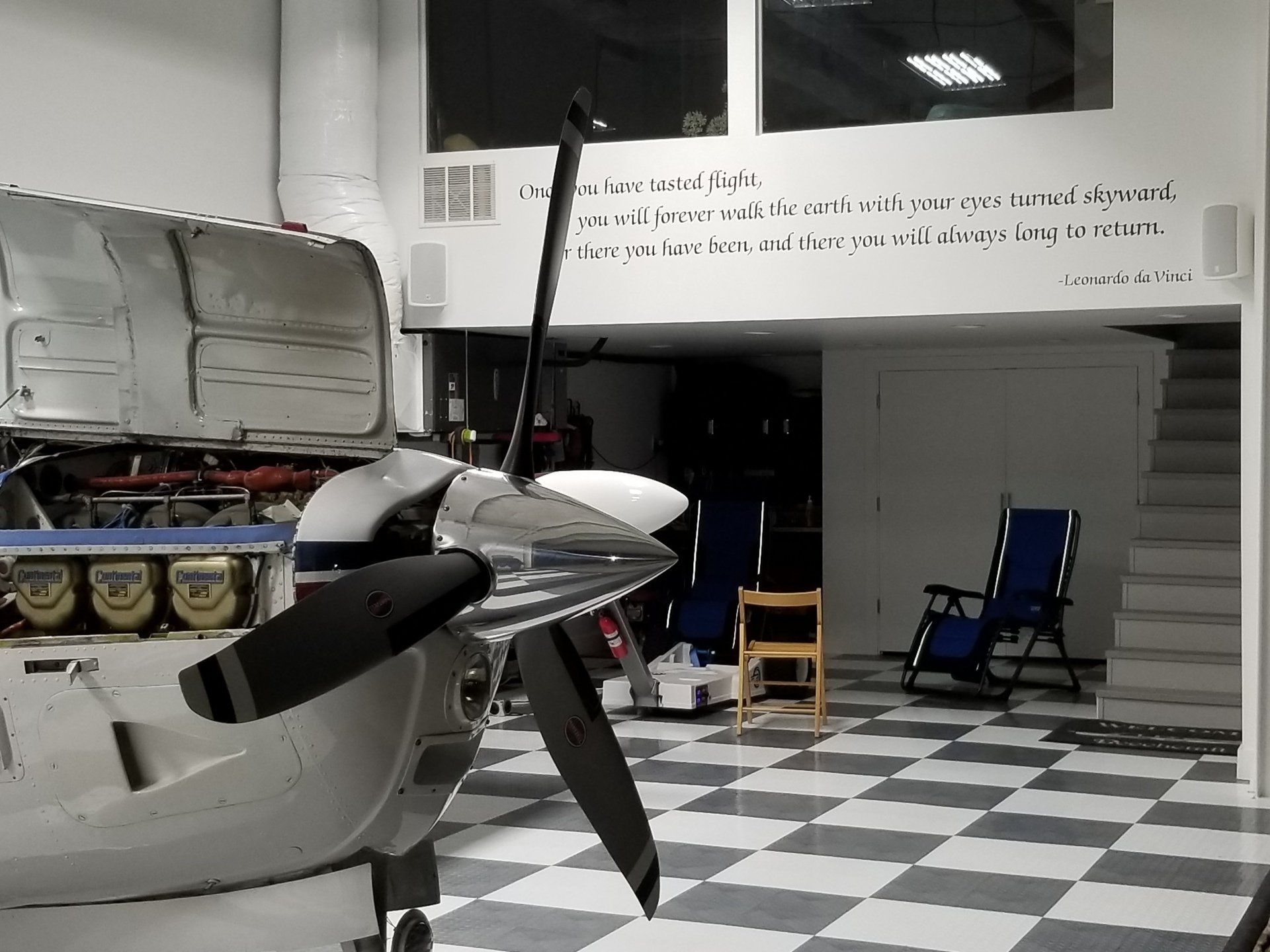 A plane is sitting in a room with a checkered floor