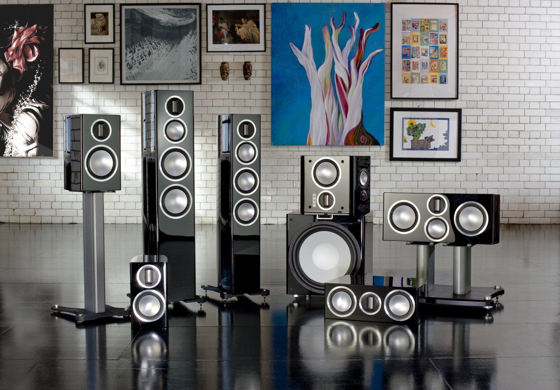 A group of speakers are sitting on stands in a room.