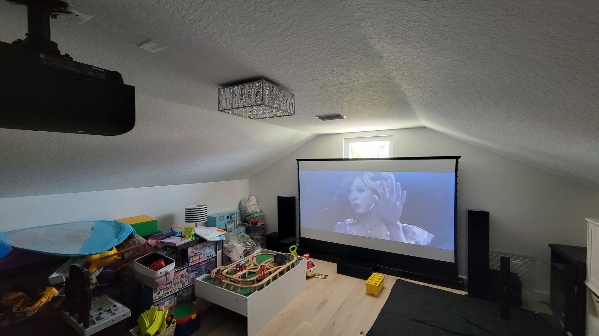 A bonus room into a home theater with a motorized rising screen and high-end audio equipment