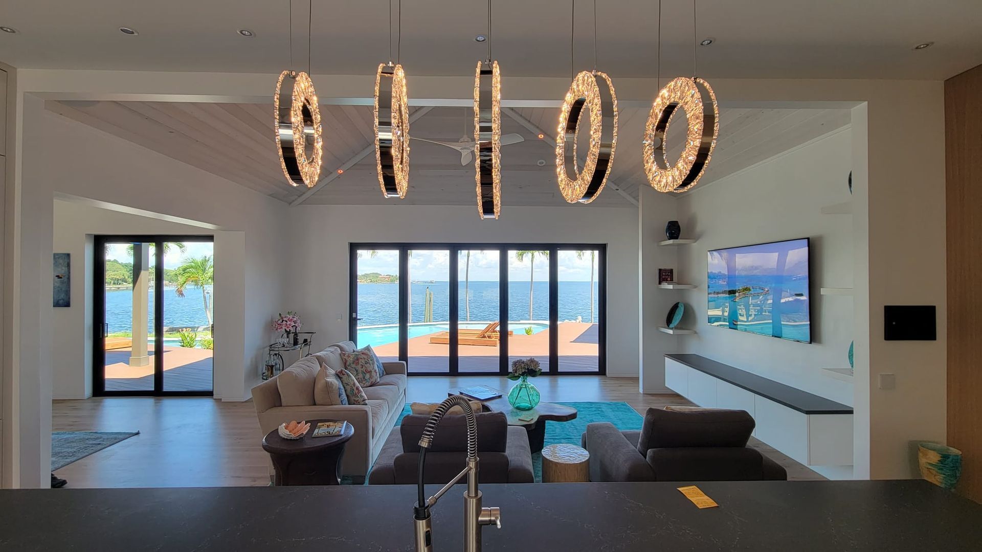 A living room with a large chandelier hanging from the ceiling