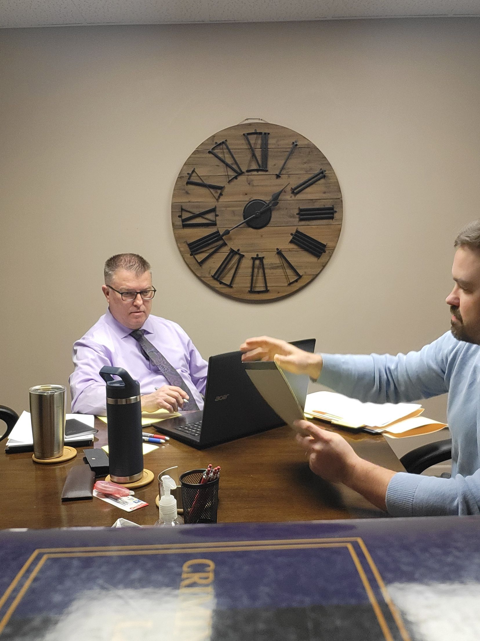 Brad Baber and Zach Baber sitting around a conference table discussing a criminal case in Whitley County, Indiana.
