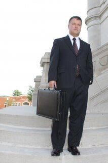 Attorney standing by courthouse - legal representation in Columbia City, IN
