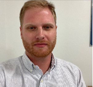 A man with a beard is wearing a striped shirt