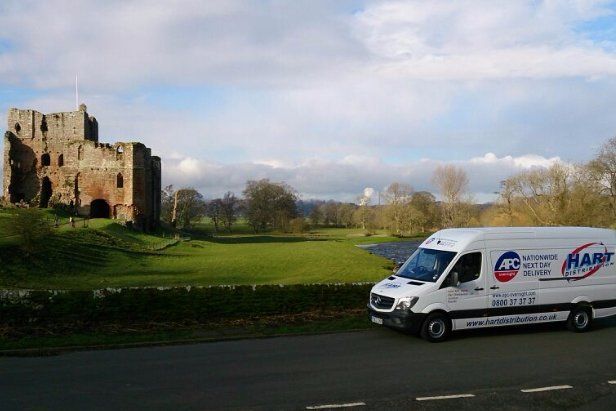 Picture of Brougham castle with Hart logo van on bridge