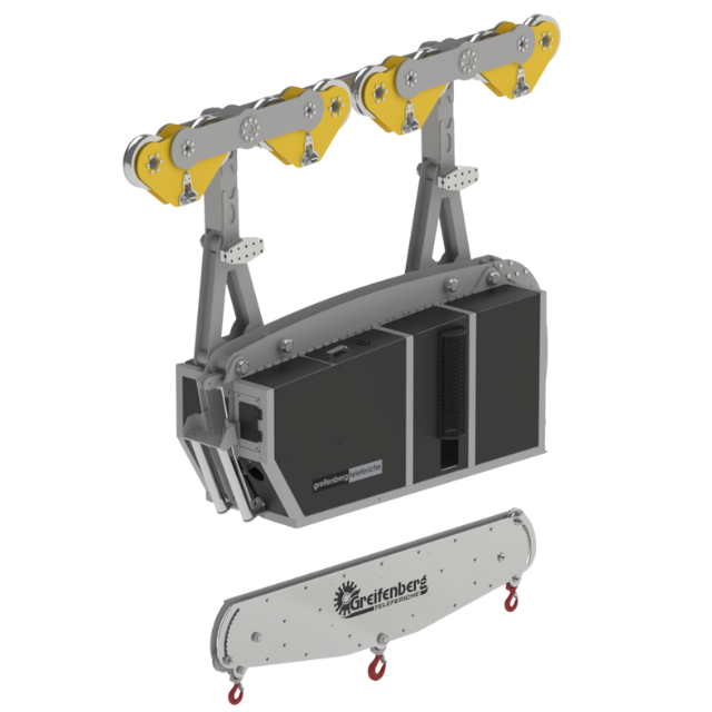 Dispositivo di sollevamento industriale con pulegge gialle, una scatola nera e una piastra argentata.