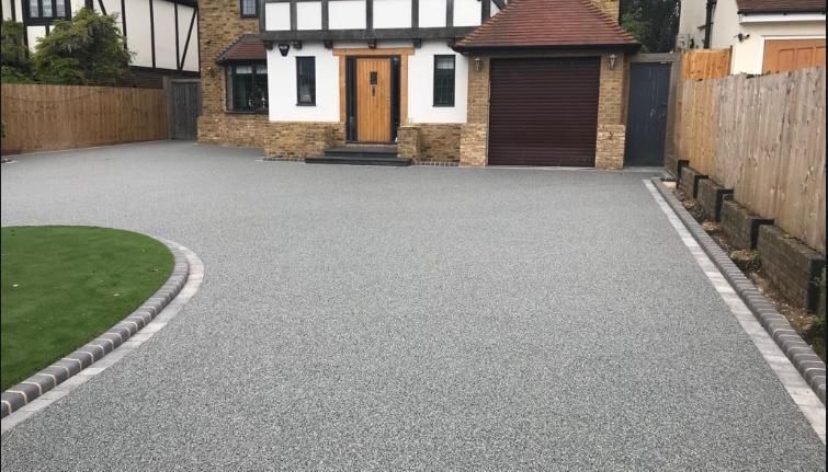 A driveway leading to a house with a garage.