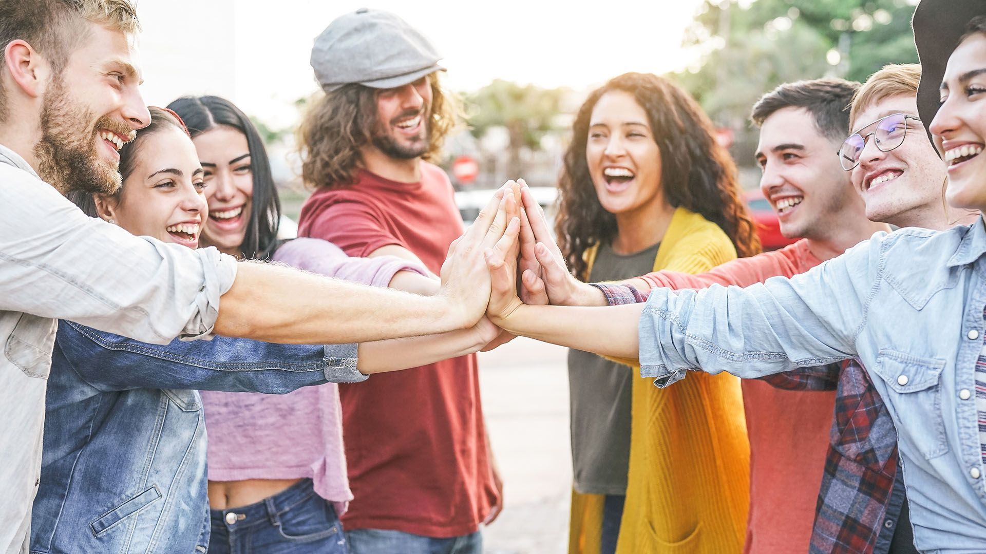 A group of young people are giving each other a high five.