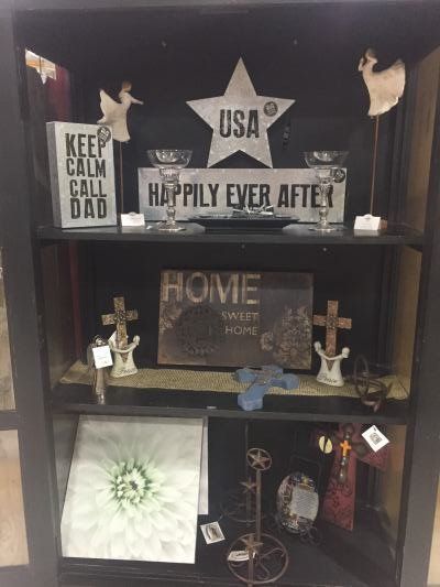 Three shelves featuring a selection of home décor. 