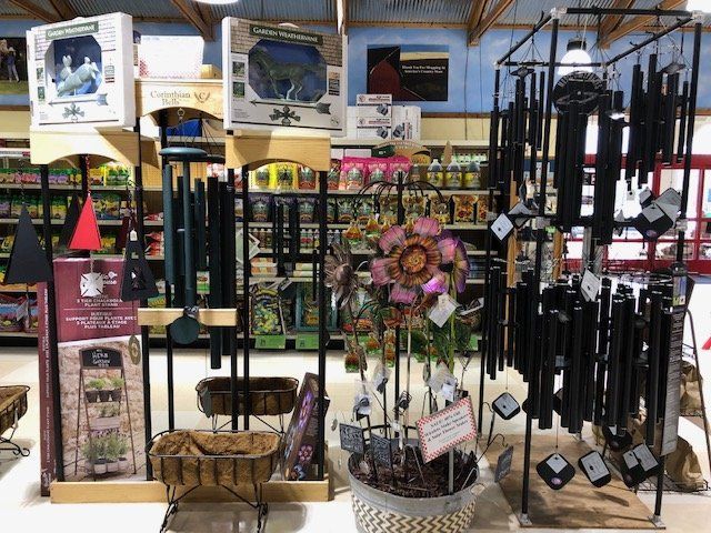Various outdoor decor, including wind chimes & colorful metal flowers