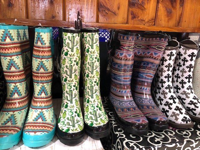Colorful rain boots on the shelf of a local pet store.