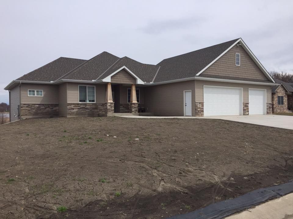 A large house with a lot of dirt in front of it