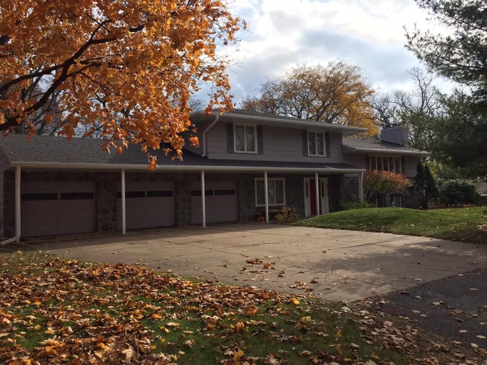 A large house with a tree in front of it