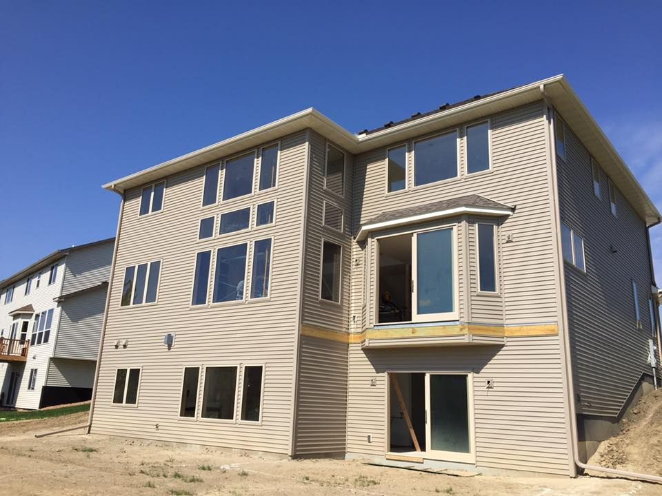 A large house with a lot of windows is being built.