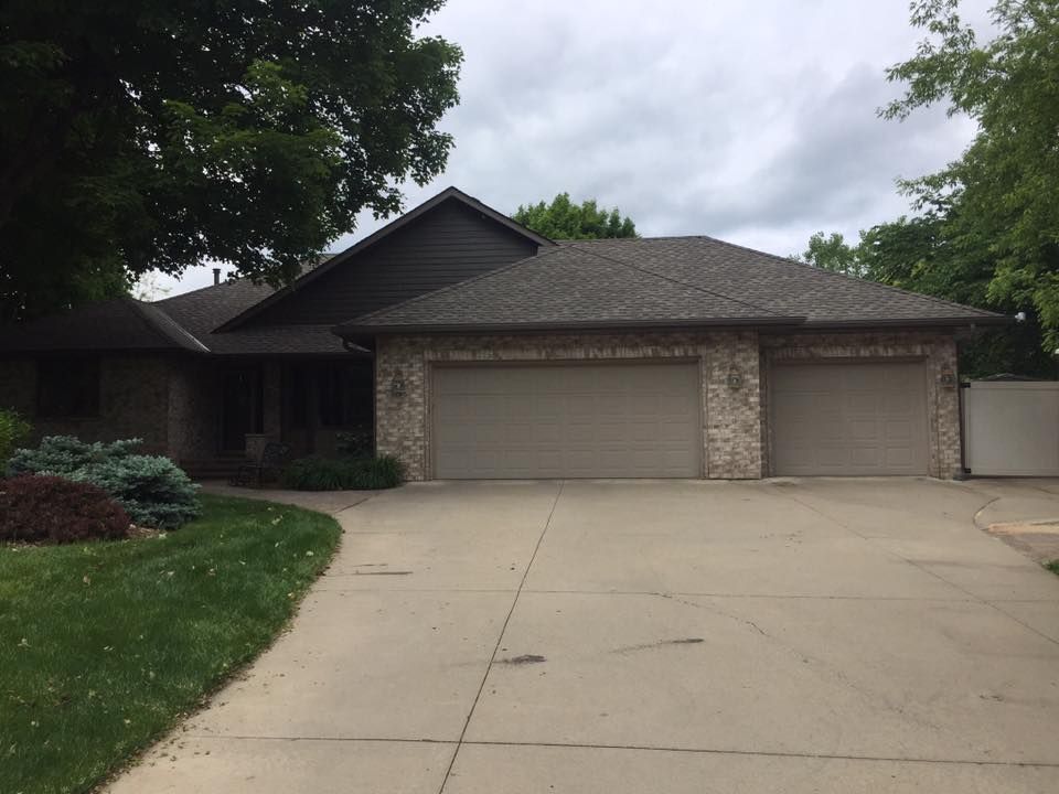A house with three garage doors and a driveway