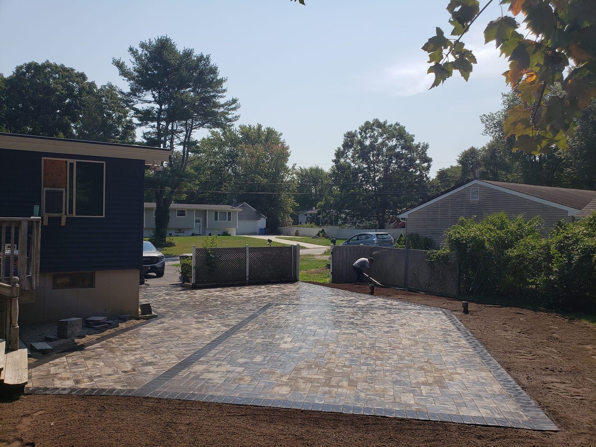 A driveway is being built in front of a house.