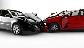 A silver car and a red car are involved in a car accident.