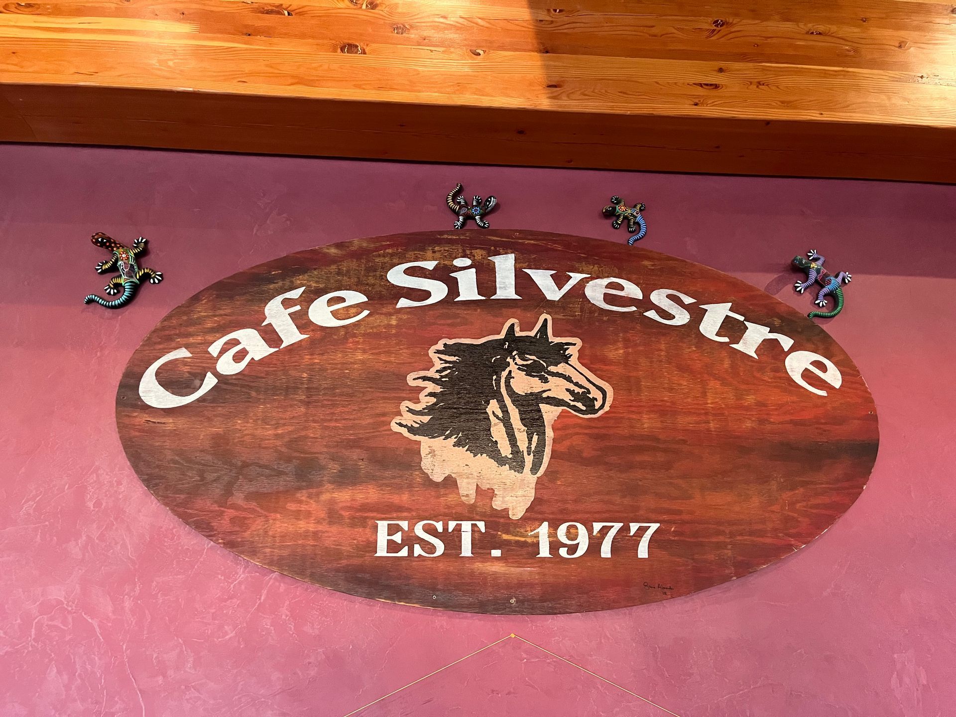 A sign for cafe silvestre with a horse on it