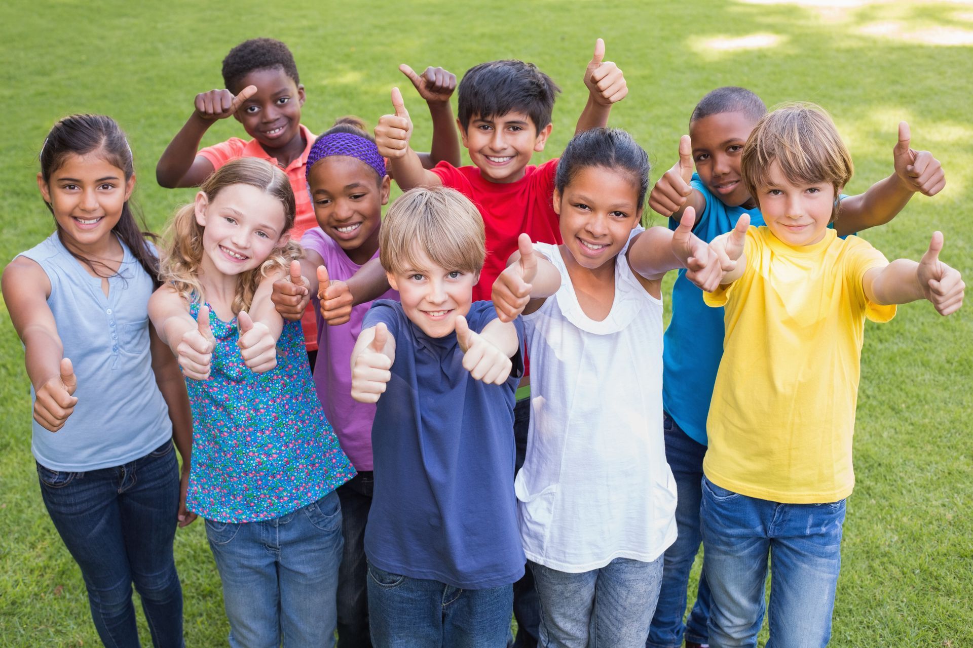 Group of children giving thumbs up