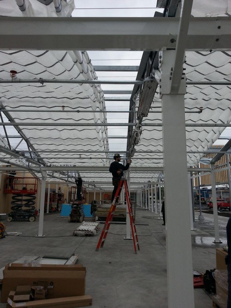 Un homme se tient debout sur une échelle dans un bâtiment en construction.