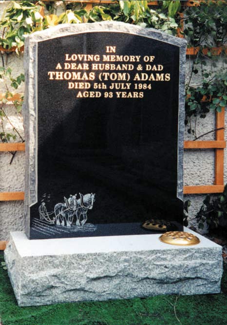 black memorial stone with writing in golden