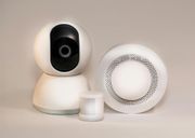 White security camera, motion sensor, and alarm system components.