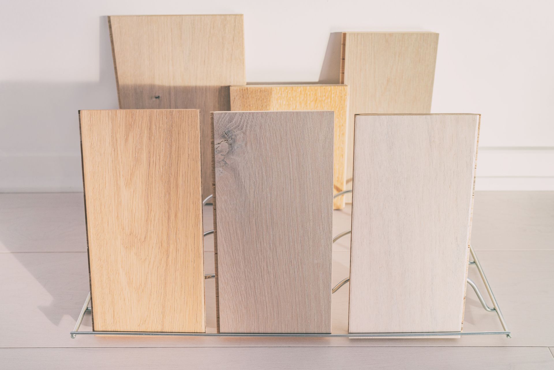 A group of wooden boards sitting on top of a glass shelf.