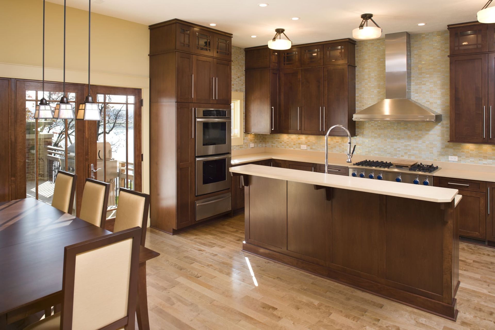 A kitchen with stainless steel appliances and wooden cabinets