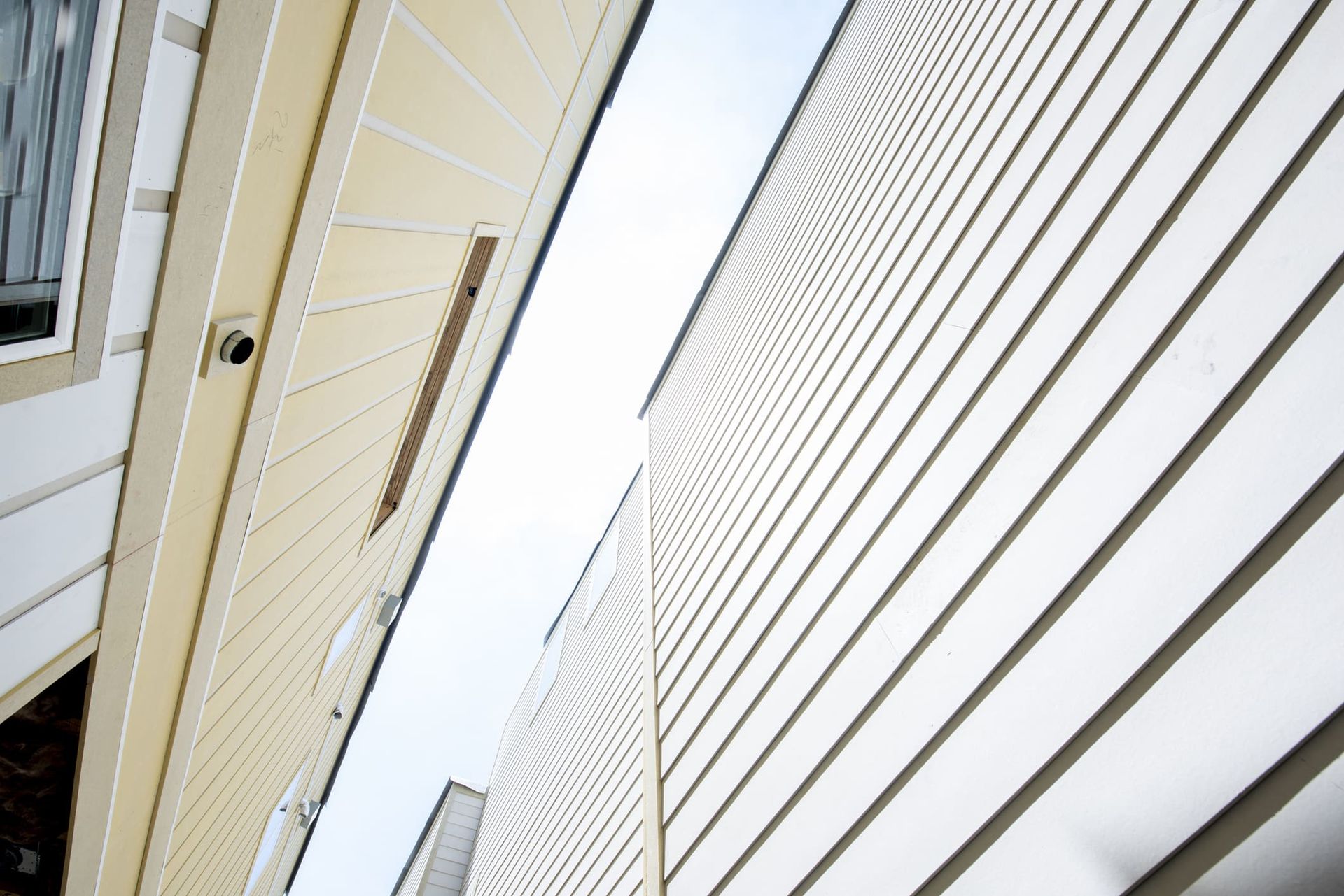 Looking up at a building with white siding