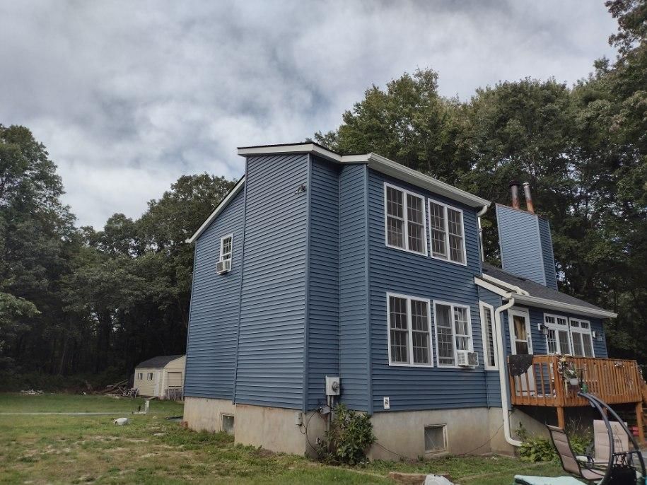 A house with two windows and shutters on the roof.