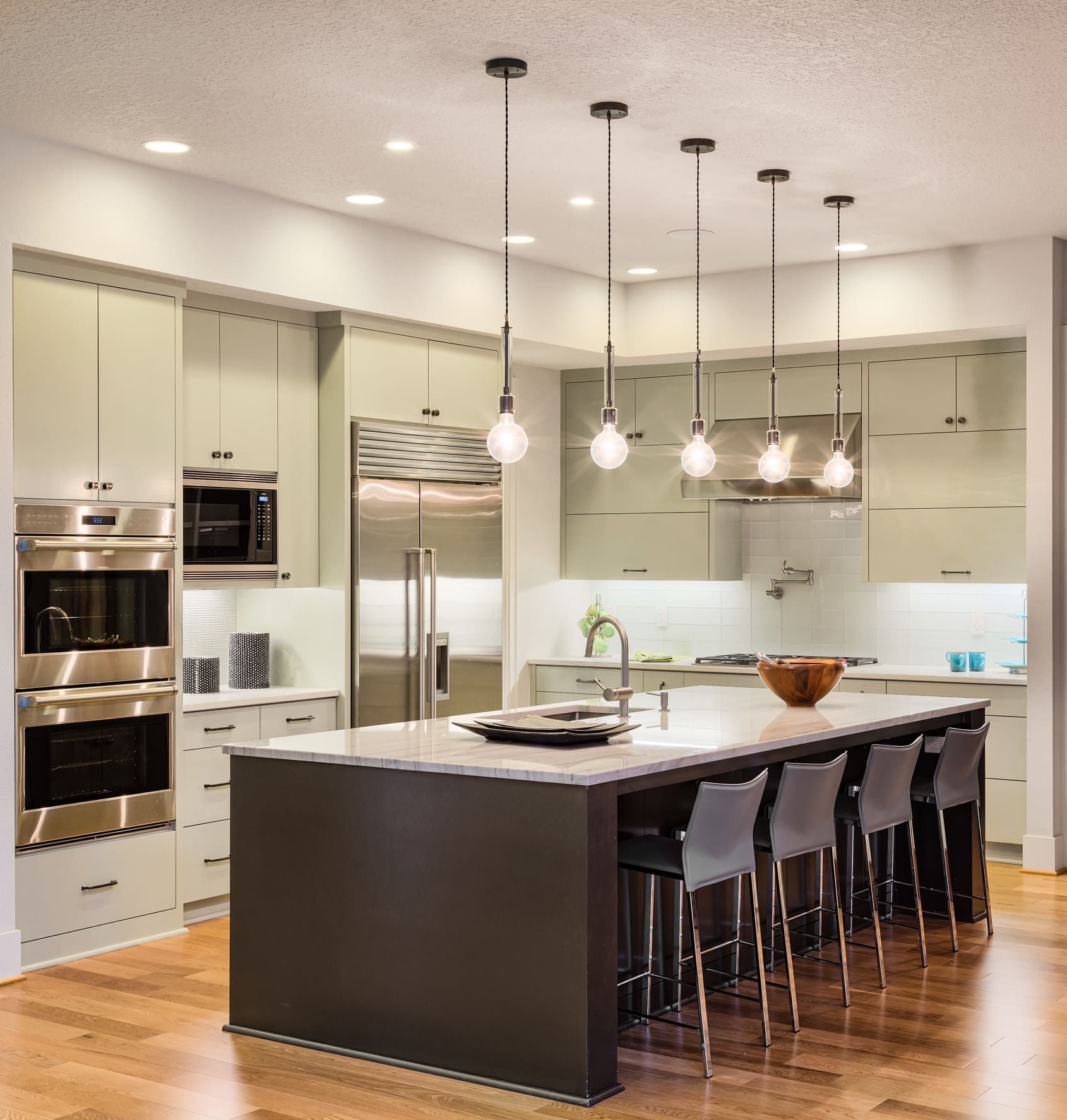A kitchen with stainless steel appliances and a large island